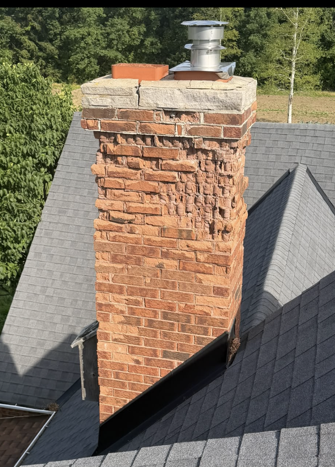 Red brick chimney with deteriorated upper brickwork before repair